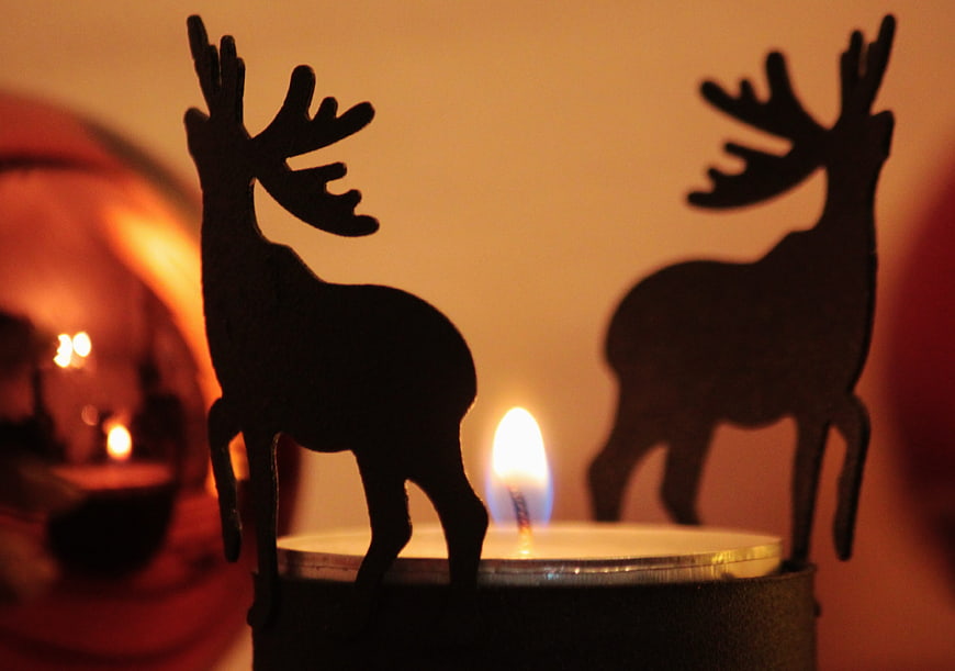 Silhouette reindeer candle holder with warm flame