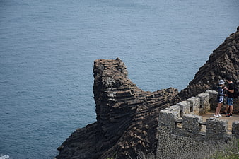 Couple viewing ocean from stone fortress on Penghu island