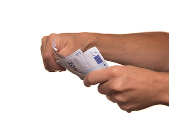 Man's hands tearing a 20 euro banknote on white background