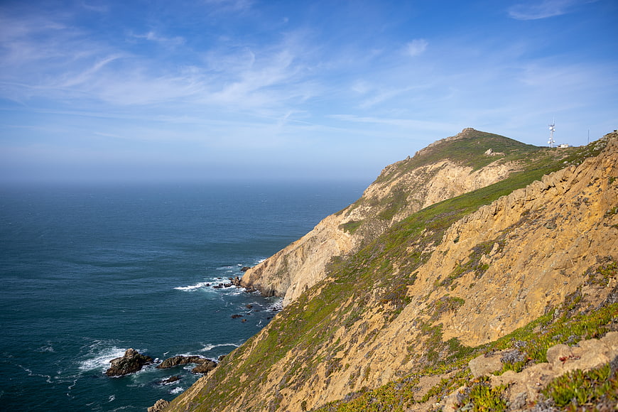 Scenic coastal cliff landscape with blue ocean and sky