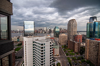 Dramatic Cityscape Skyline with Skyscrapers and Cloudy Sky