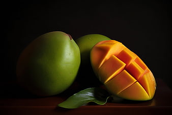 Sliced fresh mango fruit on dark background
