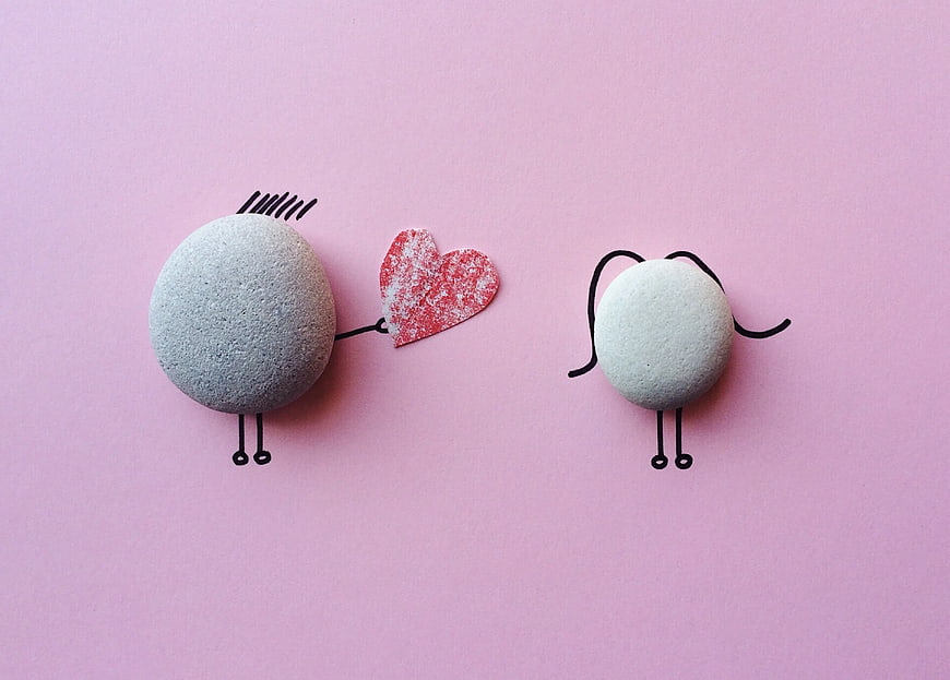Cute Stone Characters with Heart on Pink Background