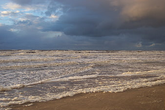 Dramatic Stormy Ocean Waves Crashing on Sandy Beach