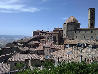 Historic Italian hilltop town with terracotta roofs and church dome
