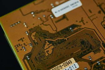 Close-up of a green circuit board with gold traces