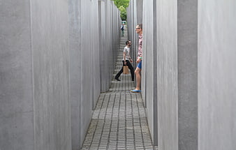 Tourists Walking Through Concrete Slabs at Holocaust Memorial