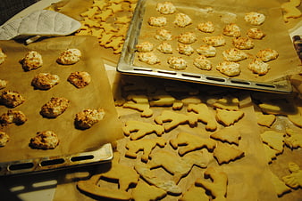 Christmas Gingerbread and Coconut Cookies Baking on Parchment Paper