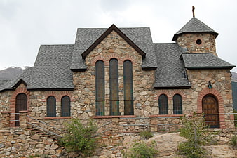 Stone chapel with stained glass windows and bell tower