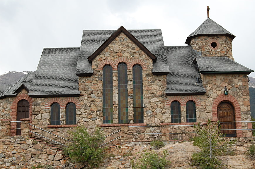 Stone chapel with stained glass windows and bell tower