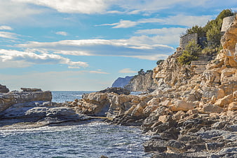Rugged Mediterranean Coastline with Rocky Cliffs and Blue Sea