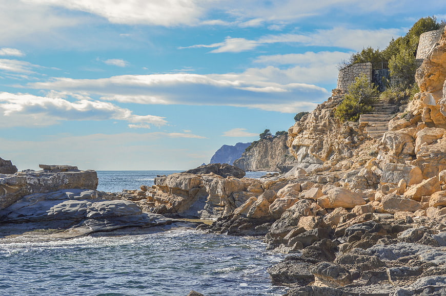 Rugged Mediterranean Coastline with Rocky Cliffs and Blue Sea