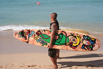Surfer with Colorful Painted Board on Sandy Beach