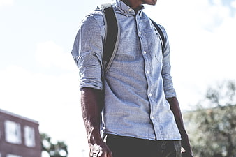 Man in Blue Shirt with Backpack Outdoors