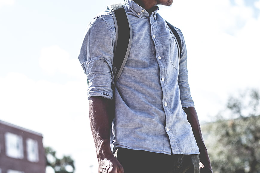 Man in Blue Shirt with Backpack Outdoors