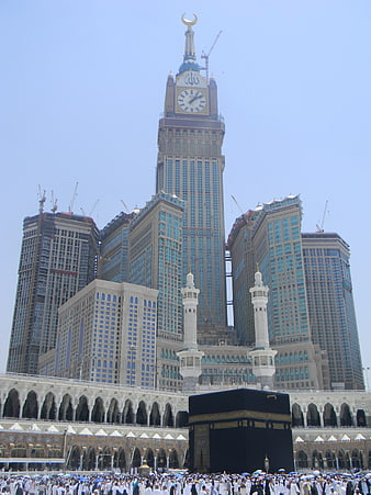 Makkah Clock Tower and Kaaba with Pilgrims in Saudi Arabia