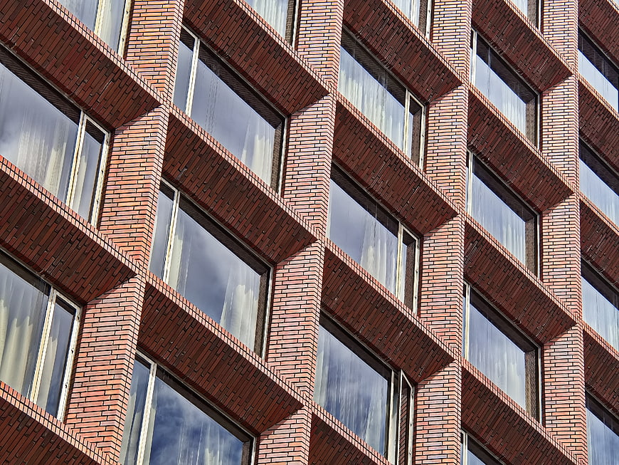 Red Brick Building Facade with Geometric Window Pattern