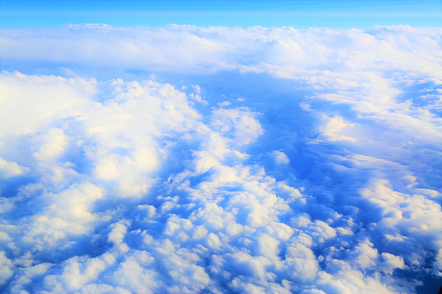 Aerial View of Fluffy White Clouds in Blue Sky