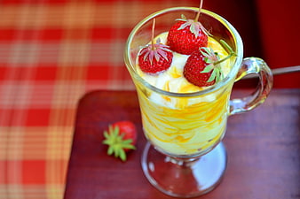 Strawberry and Cream Dessert in Glass Mug on Wooden Table