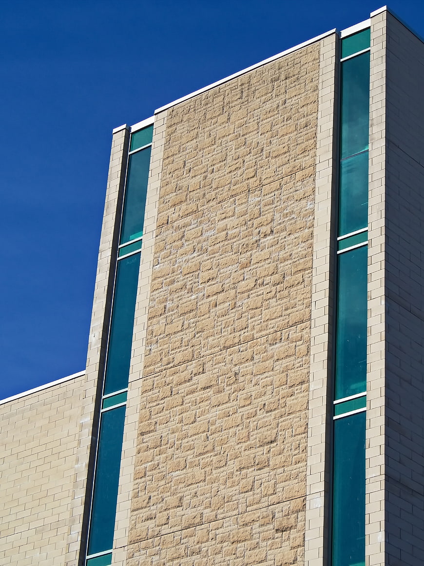 Modern Building Facade with Stone and Glass Windows