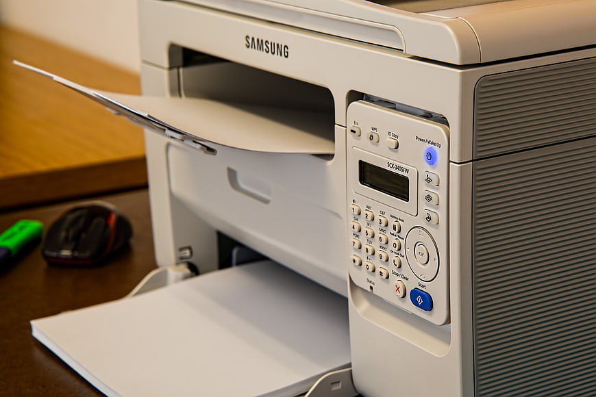 Samsung Laser Printer Printing Document On Office Desk