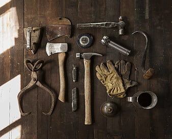 Vintage Rustic Hand Tools Arranged On Dark Weathered Wooden Planks