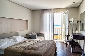 Modern Hotel Bedroom with Balcony and Sea View