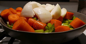 Chopped mirepoix vegetables in a frying pan ready to cook