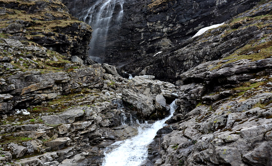 Rugged Mountain Waterfall Cascading Over Rocky Terrain
