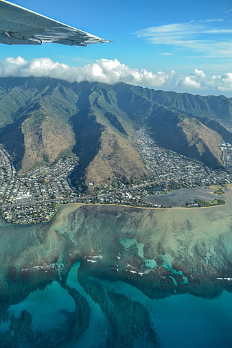 Aerial View of Oahu Coastline with Airplane Wing