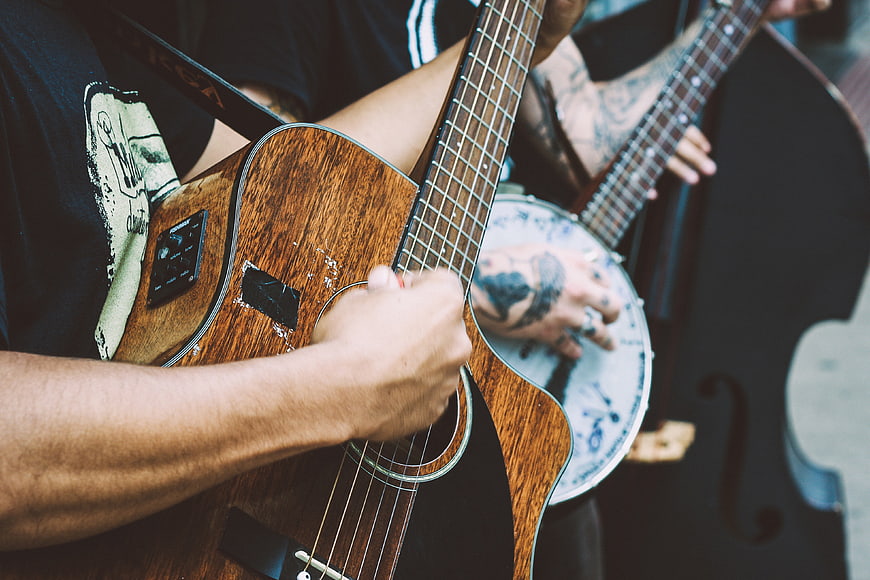 Close-up of musicians playing acoustic guitar and banjo