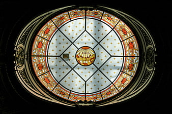 Ornate stained glass dome ceiling with religious symbols