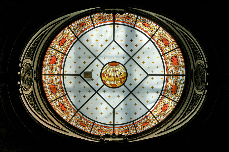 Ornate stained glass dome ceiling with religious symbols