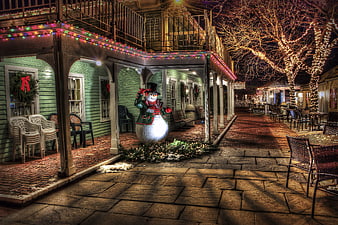 Festive Christmas Town Square with Snowman at Night