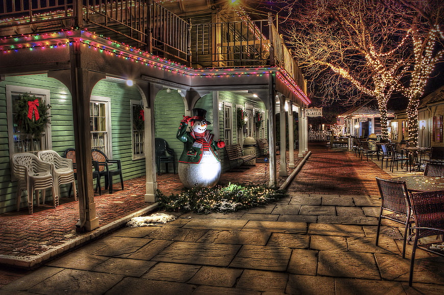 Festive Christmas Town Square with Snowman at Night
