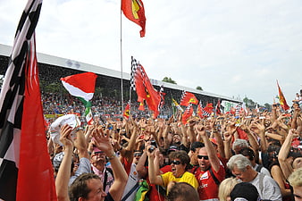 Ferrari Fans Celebrating With Flags At Formula 1 Race