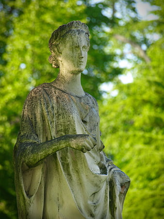 Weathered Stone Statue of Woman in Garden