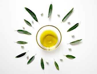 Top View of Olive Oil Bowl with Leaves and Garlic