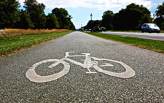 Low angle view of bicycle symbol on paved cycle path