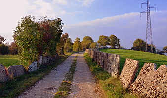 Hikers on a gravel trail in the Italian countryside