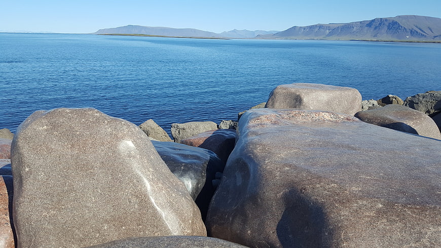 Smooth Granite Boulders on Rocky Coastline with Blue Sea