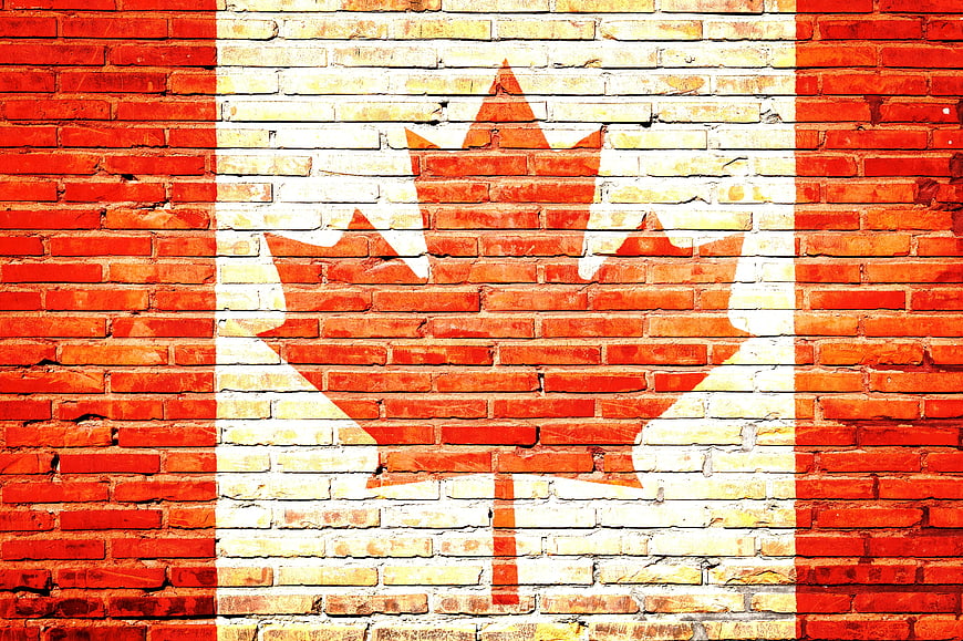 Canadian flag painted on red brick wall texture