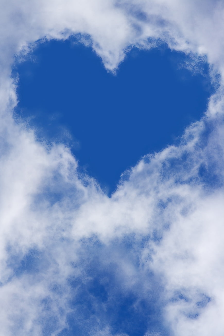 Heart-shaped cloud formation in blue sky