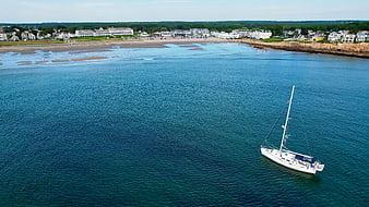 Aerial View of Sailboat Anchored in Blue Coastal Waters