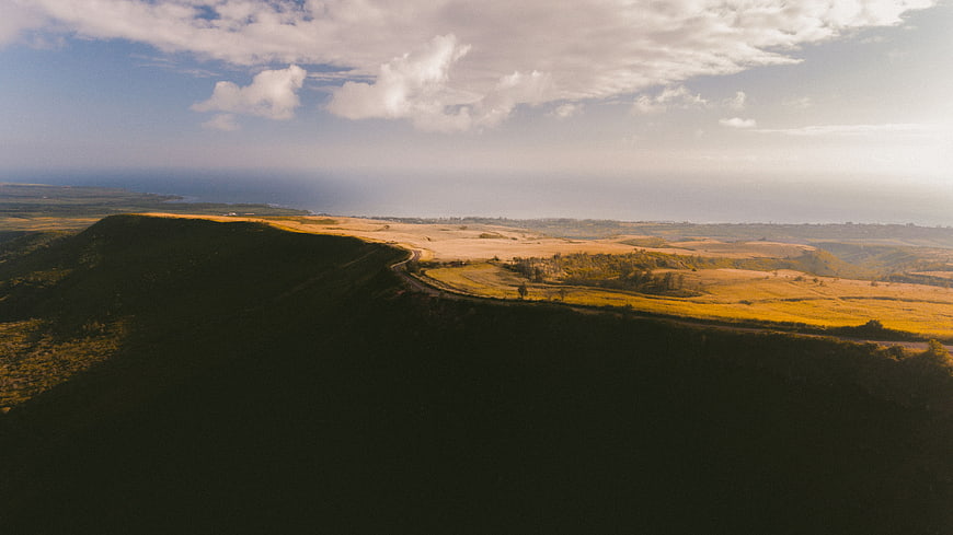 Aerial View of Rolling Hills and Winding Road at Sunset