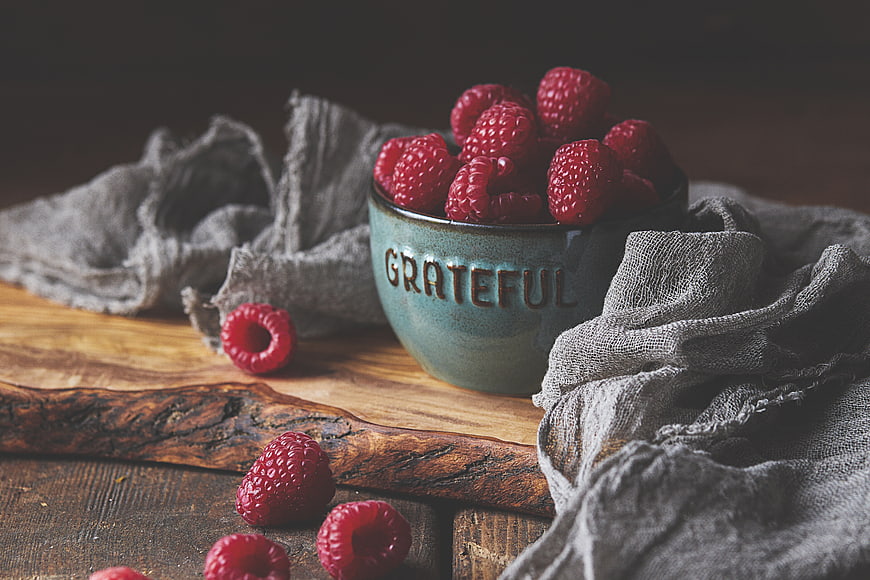 Raspberries in Grateful Bowl on Rustic Wood