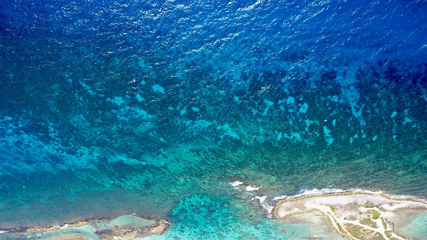 Aerial View of Turquoise Ocean Water and Coral Reef