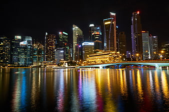 Singapore skyline at night with reflections on water
