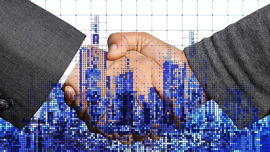Business handshake with digital city skyline overlay