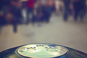Close-up of a glossy ball with a crown logo and blurred crowd background